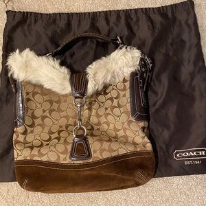 Gently used like new coach shoulder bag with fur trim.